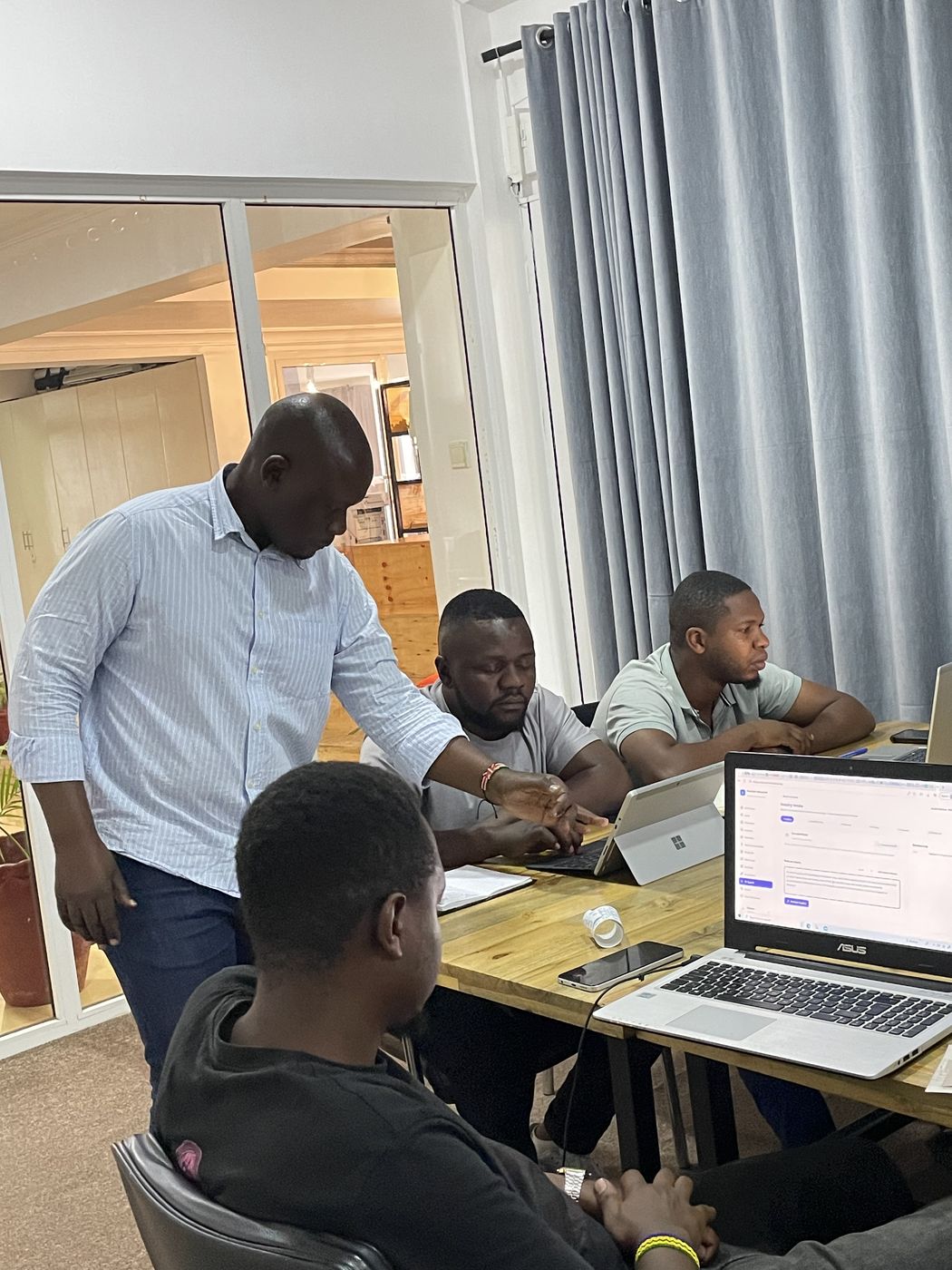 Facilitator coaching founders at their laptops